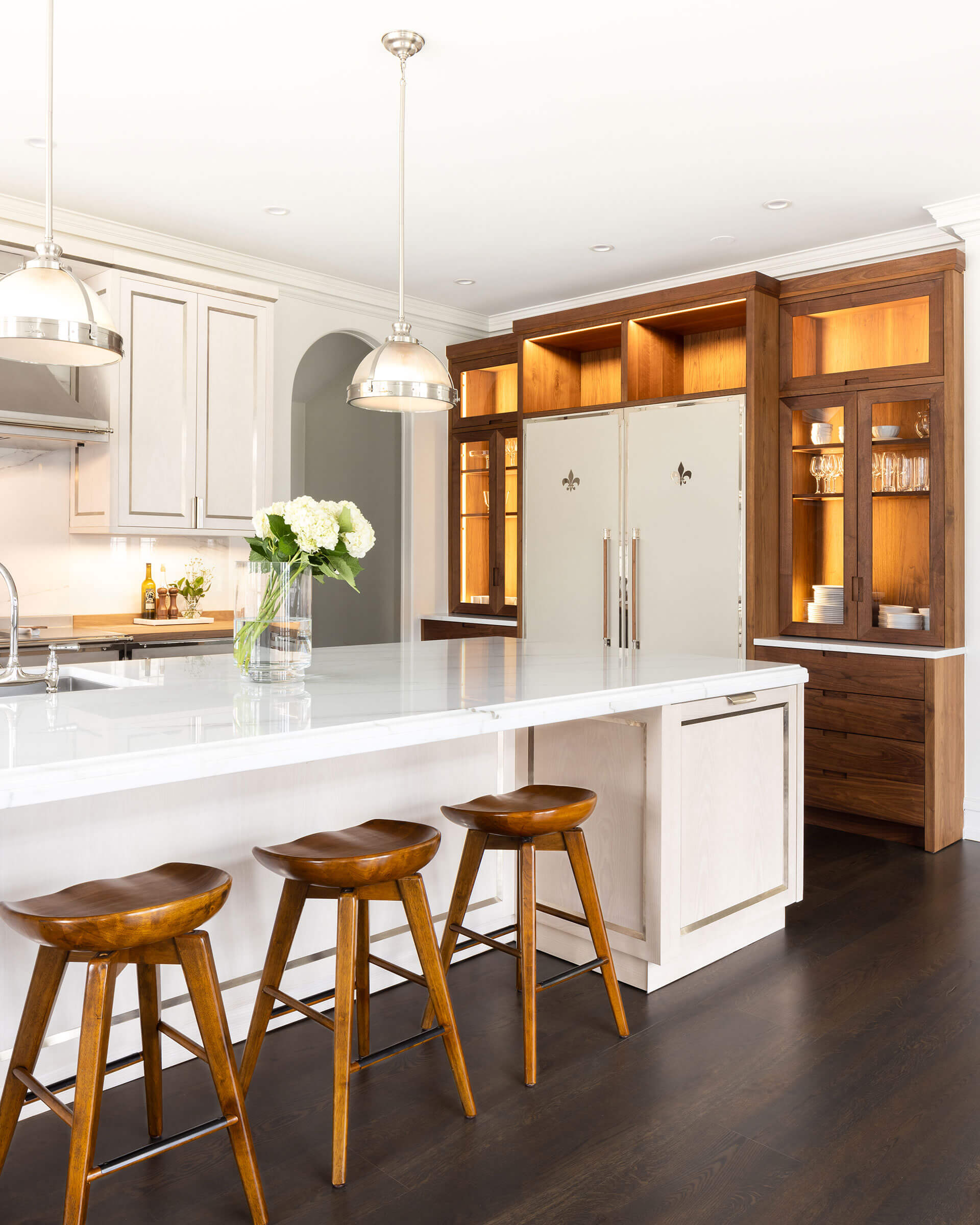 white kitchen with wooden kitchen cabinets and lightings